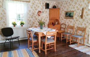 a dining room with a table and chairs at One-Bedroom Holiday Home In Vislanda in Vislanda