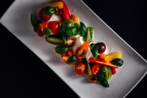 a white plate with vegetables in the shape of a heart at Hotel-Restaurant Bellevue in Flims