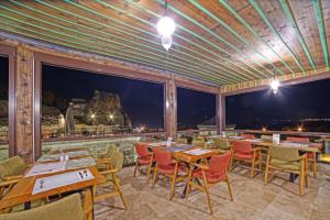 a restaurant with wooden tables and chairs and a view at Taru Cave Suites in Urgup +37 photos