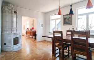 a dining room with a table and a fireplace at Awesome Apartment In Visby With 3 Bedrooms And Wifi in Visby