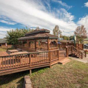 a large wooden gazebo in a park at Bullwinkles Rustic Lodge in Poplar Bluff