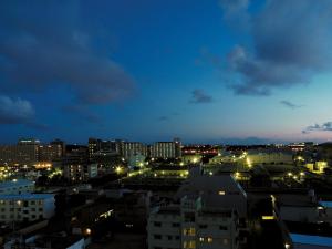 a view of a city at night with lights at Naha Beach Side Hotel in Naha