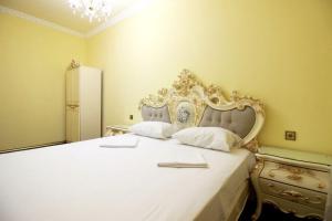 a bedroom with a large white bed with a headboard at AL SHEIKH 5 BEDROOM LUXURY APARTMENT 1 in Yerevan