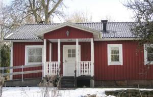 una casita roja con una puerta blanca en Holiday Home Agunnaryd with Fireplace VII, en Agunnaryd
