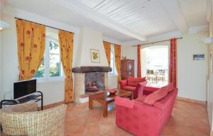 a living room with red furniture and a fireplace at Gorgeous Home In Cabris With Wifi in Cabris