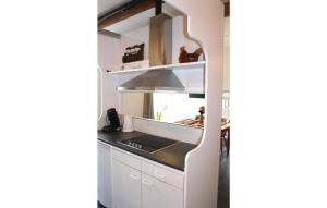 a kitchen with white cabinets and a stove top oven at Cozy Home In De Meern With Wifi in Utrecht