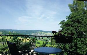 a table and chairs on a balcony with a view at Holiday home Am Hohen Rad W in Schwarzenberg