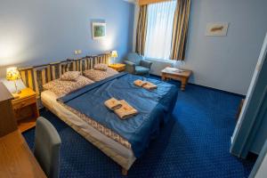 Postel nebo postele na pokoji v ubytování Hotel Rustikal