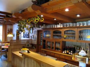 a restaurant with a bar with bottles of wine at Landgasthof Zur Mühle in Naila