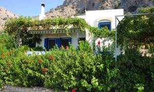 a house with flowers in front of it at Villa Panorama in Pefkos in Pefki
