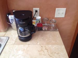 a coffee maker sitting on a counter next to a sink at La Posada Pintada in Bluff
