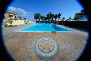 a swimming pool with a mosaic in the middle at Case Vacanze Ancora in Porto Empedocle