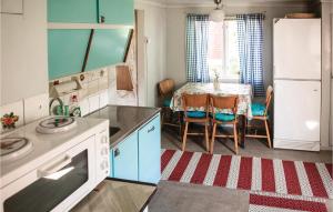 a kitchen with a table and a dining room at 3 Bedroom Lovely Home In Vimmerby in Vimmerby