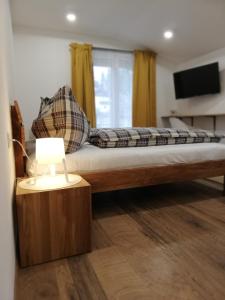 a bedroom with a large bed with a night stand at Gästezimmer Klopfer in Sankt Johann im Saggautal