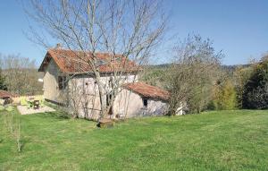 a small white house with a red roof in a field at 2 Bedroom Nice Home In Grignols in Grignols Dordogne