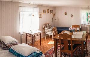 a living room with a table and a dining room at 3 Bedroom Lovely Home In Vimmerby in Vimmerby
