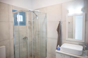 a bathroom with a shower and a sink at climbers village in Kalymnos