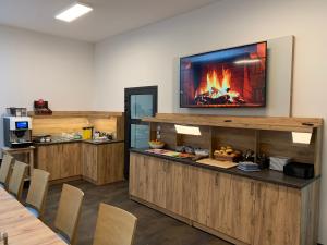 a restaurant with a fireplace on the wall at besttime Hotel Monschau in Monschau