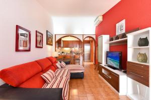 a living room with a couch and a tv at Jacuzzi & Garden Holiday Home in Playa del Ingles