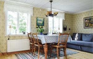 a dining room with a table and chairs and a couch at Lovely Home In Virserum With Wifi in Virserum