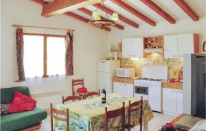a kitchen and dining room with a table and chairs at 2 Bedroom Awesome Home In Teyssieres in Teyssières