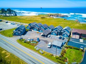 an aerial view of a beach with houses and a road at Surf and Sand Lodge in Fort Bragg