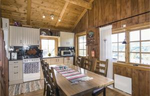 a kitchen with a large wooden table and chairs at Cozy Apartment In Sysslebck With Sauna in Sysslebäck