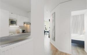 a white apartment with a kitchen and a bedroom at Highend Travemünde - Whg 113 in Travemünde +18 photos