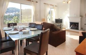 a living room with a table and a couch at Awesome Home In Monda With 3 Bedrooms, Wifi And Outdoor Swimming Pool in Monda
