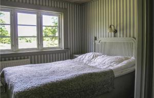 A bed or beds in a room at Stunning Home In Lidhult With Wifi