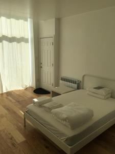 a bedroom with a bed and a large window at Apartment Ocean Block in Brooklyn