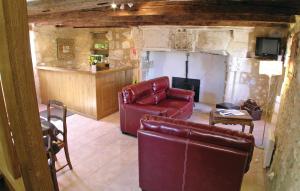a living room with a leather couch and a chair at 2 Bedroom Nice Home In Grignols in Grignols Dordogne +5 photos