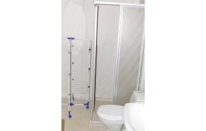 a bathroom with a toilet and a glass shower door at 2 Bedroom Awesome Home In Älvdalen in Blyberg