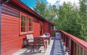 a deck of a red house with chairs and a table at Stunning Home In mli With 4 Bedrooms in Felli