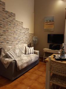 a living room with a couch and a tv at Kefallonia Bay Resort in Spartià +97 photos