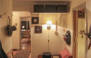 a room with a hallway with a lamp on the wall at 5 Bedroom Lovely Home In Seim in Seim +7 photos