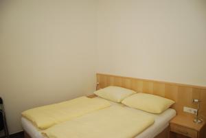 a bed with two pillows on it in a room at Haus Schraberger in Schladming