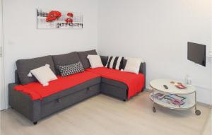 a living room with a couch and a table at Nice Apartment In Gruissan With Kitchen in Gruissan +6 photos