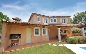 a large house with a fireplace in a yard at Awesome Home In Fayence in Fayence