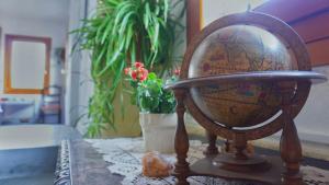 a wooden globe sitting on a table with a plant at B&BTorre Cives in Vidracco +37 photos