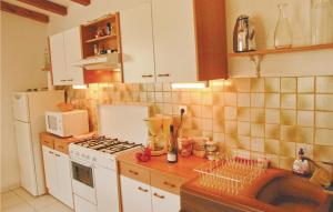 a kitchen with a sink and a stove top oven at 2 Bedroom Awesome Home In Teyssieres in Teyssières +3 photos