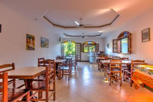 a dining room with wooden tables and chairs at Pousada Barra da Tijuca in Rio de Janeiro