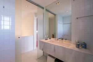 a bathroom with a sink and a large mirror at LovelyStay - Two Bedroom Duplex at Vilamoura Marina in Vilamoura +29 photos