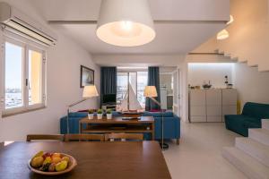 a living room with a table and a blue couch at LovelyStay - Two Bedroom Duplex at Vilamoura Marina in Vilamoura