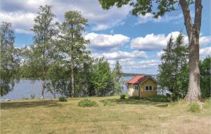 a small cabin on the shore of a lake at Beautiful Home In Nässjö With Kitchen in Nässjö