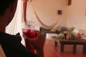 a person holding a glass of red drink at La Casa de Hercilia Boutique in Barichara +25 photos