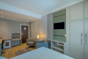 Postel nebo postele na pokoji v ubytování Hotel Glória Blumenau
