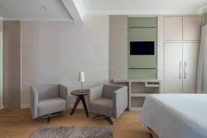 TV a/nebo společenská místnost v ubytování Hotel Glória Blumenau