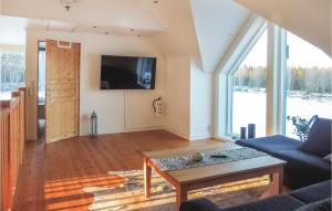 a living room with a couch and a table at Beautiful Home In Aneby With Wifi in Aneby