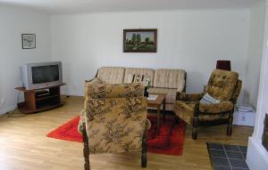 - un salon avec deux chaises et une télévision dans l'établissement 2 Bedroom Cozy Home In Bredaryd, à Sporda